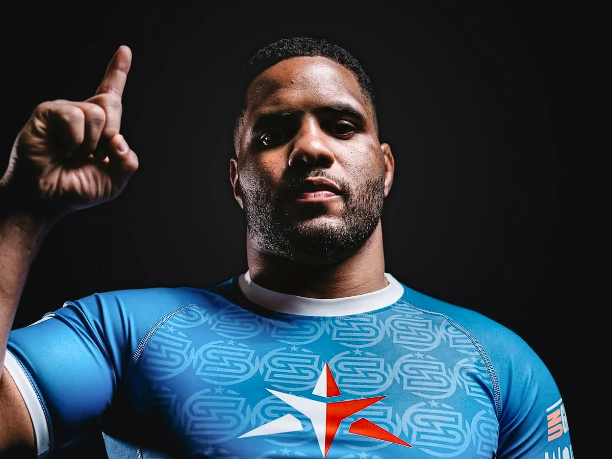 Isaque Bahiense in a blue rash guard, studio portrait